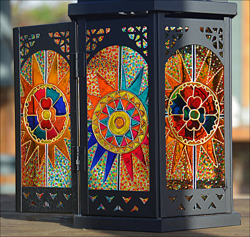 A bright & elegant stained glass Moroccan lantern showing 3 panels of delicately hand painted Indian tapestry abstract design