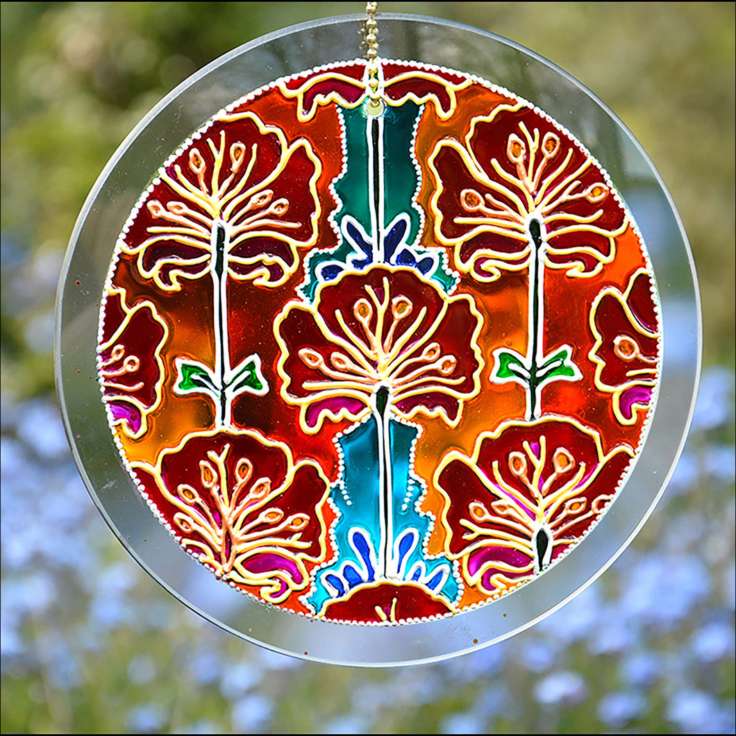 Painted Art Nouveau styled red & pink poppies against a background of orange, gold & turquoise on a stained glass suncatcher