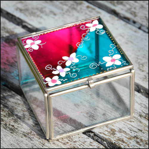 Small glass jewellery or keepsake box with the lid hand painted in pink & turquoise, and patterned with little white daisies