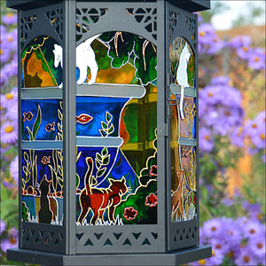 A large fish pond - with colourful fish, water plants and fishing cats - stretches all the way round a garden candle lantern