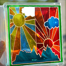 A large stained glass block hand painted with a colourful sunrise and sunset design in the Art Deco style of Clarice Cliff