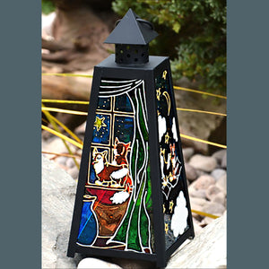 A stained glass garden lantern with a black frame, decorated with paintings of two Pembroke Corgis against a night sky