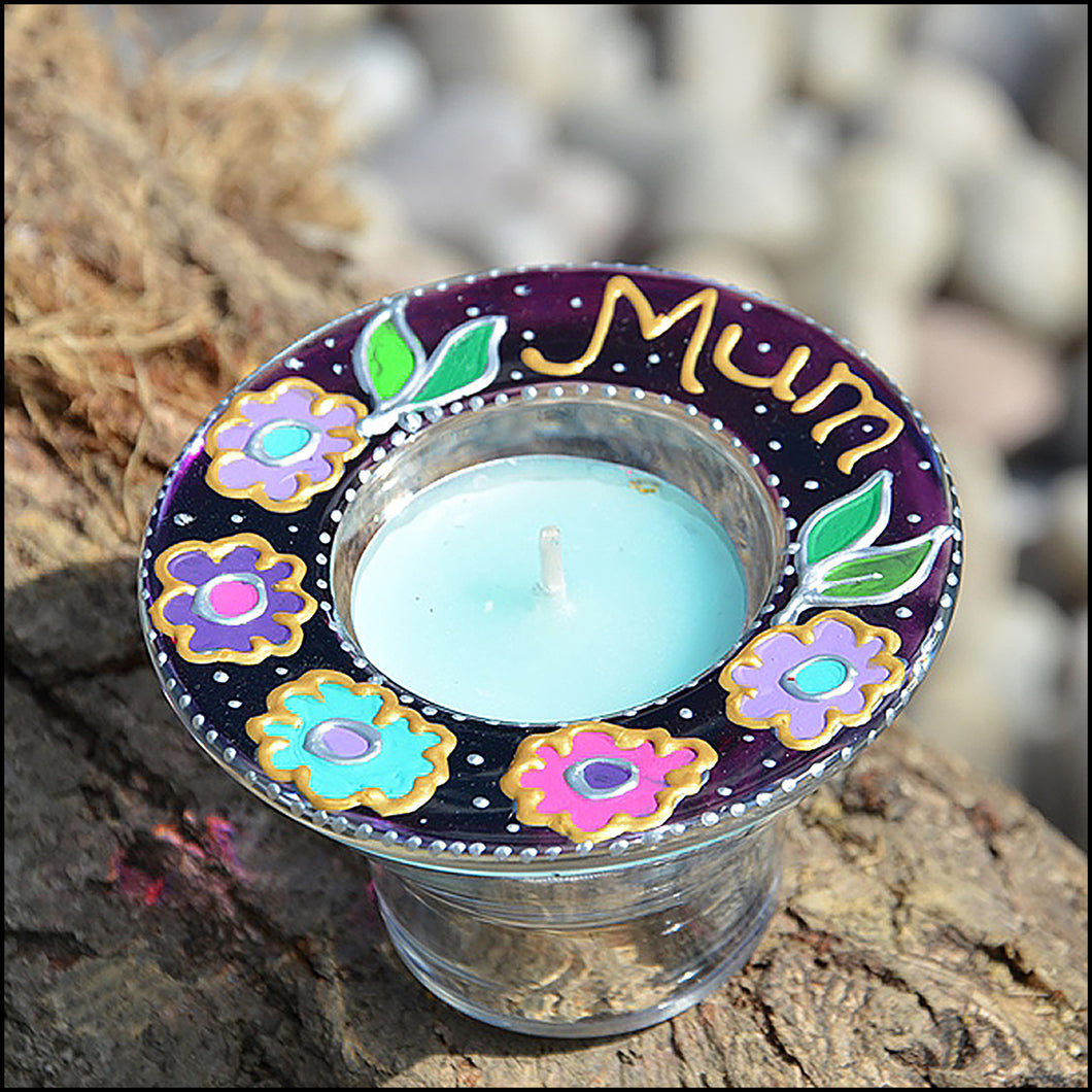 A stained glass tealight holder painted in deep purple with brilliant pink & mauve flowers and personalised for Mum in gold