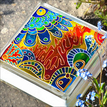 Stained glass nightlight or suncatcher made from a glass block and painted with an abstract pattern in blue, yellow and gold