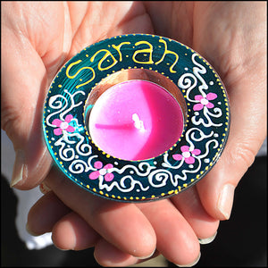 Stained glass tealight candle holder hand painted in turquoise blue with tiny pink daisy flowers, personalised for Sarah