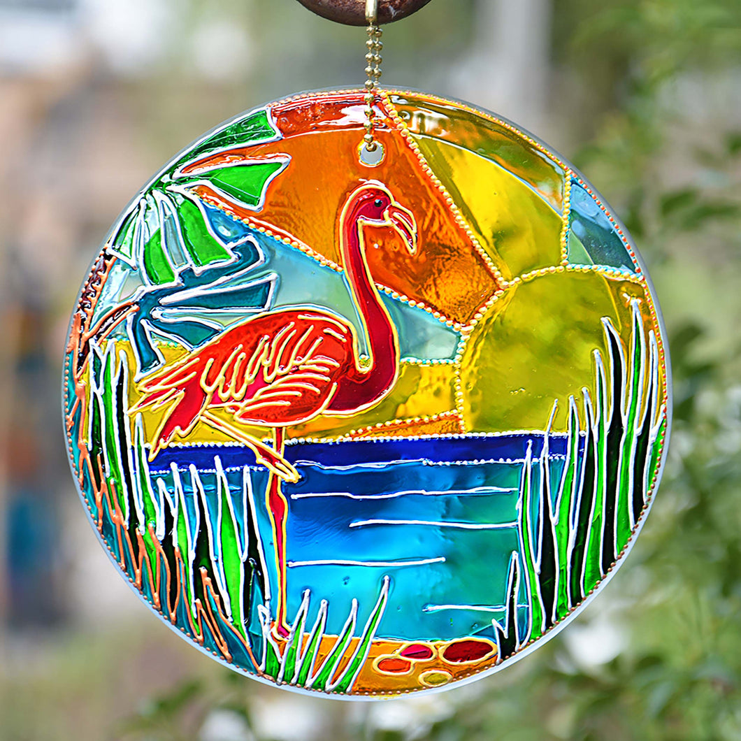 A fabulous Florida flamingo enjoys the gold sunshine, green reeds & blue waters on this hand painted stained glass suncatcher