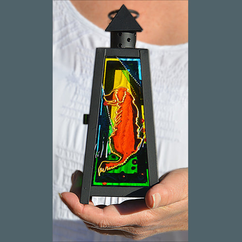 A small black tealight candle lantern has stained glass panels hand painted with golden retriever dogs – great garden décor!