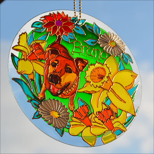 Hanging stained glass pet memorial suncatcher personalised for Bruno, who is painted amongst sunny Spring daffodils & daisies