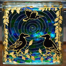 A stained glass block suncatcher or night light, dramatic black rooks and gold leaves against a swirling green blue backdrop
