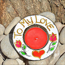 A glass tealight holder hand painted in white & patterned with a red heart, pink roses & the words To My Love written in gold