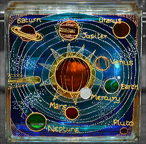 A stained glass block suncatcher or night light, featuring a colourful solar system with all nine planets and a central sun