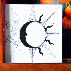A small square black and white illustration gift card with an Art Deco style sun and moon drawn in pen and ink