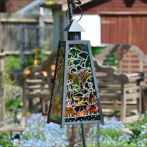 Hanging garden lantern for candles with colourful stained glass, patterned with dog walkers in the seasonal countryside